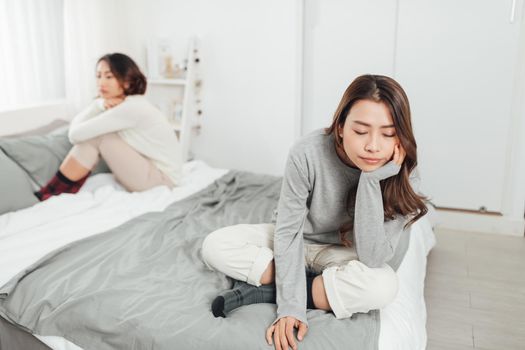 Two young aisan women having quarrel at home