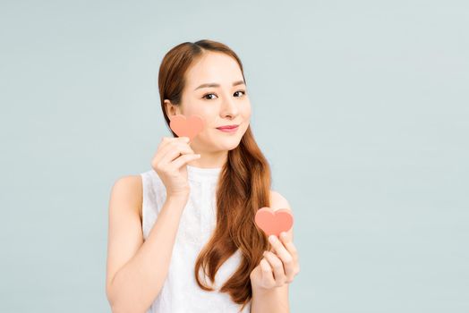 Portrait of charming lady holding papercard heart looking smiling 