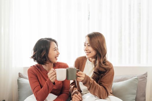 girlfriends friends drink tea on the couch