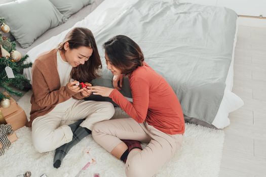 two wonderful beautiful young asian women paint nails going pedicures, one of them blows on nails