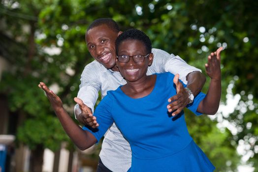 Portrait of young happy african couple doing gestures of hands.