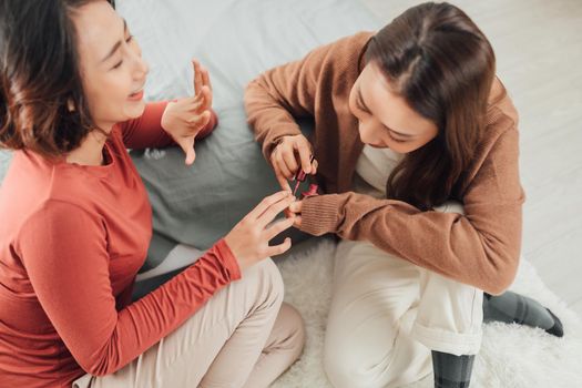 Beautiful Young Girl Does Manicure to Friend