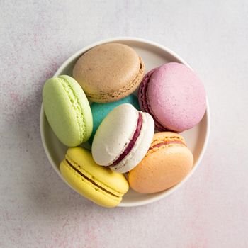 French dessert colorful macaroons on the plate, minimal concept flat lay