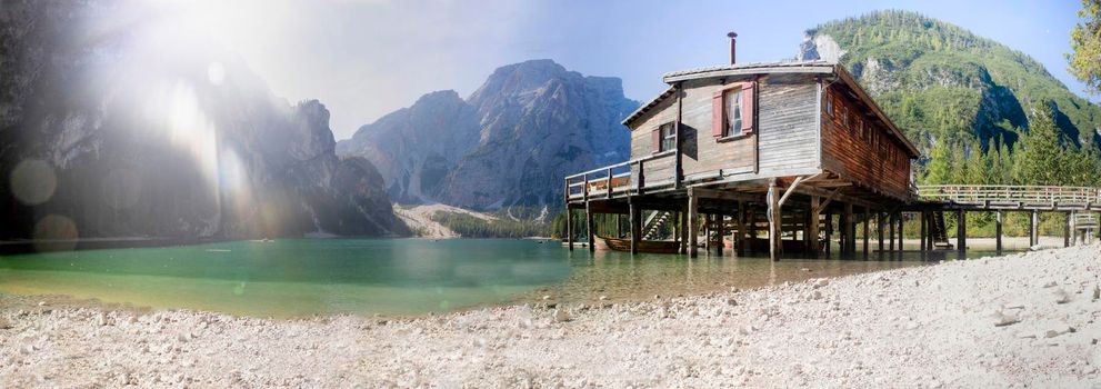 Panoramic shot of the characteristic wooden stilt house located in Lake Braies in the Italian Dolomites mountain range 