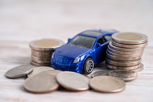 Car on stack of coins. Car loan, Finance, saving money, insurance and leasing time concepts.