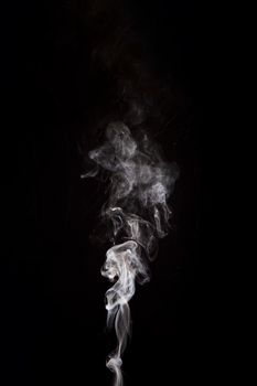 white smoke raising black background with copy space. Beautiful photo