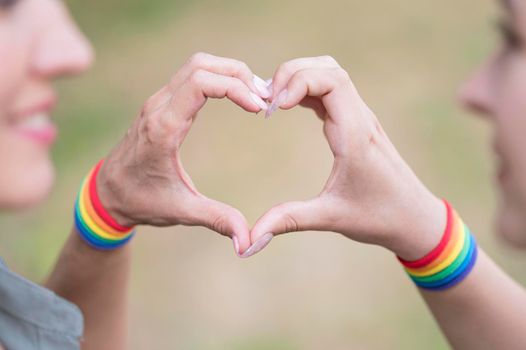 lesbian couple with lgbt bracelete. High resolution photo