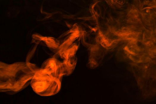 dense fumes abstract orange smoke dark background. High resolution photo