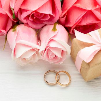 close up pink roses wedding rings. High resolution photo