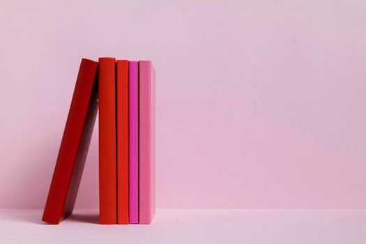 colorful books with pink background. High resolution photo