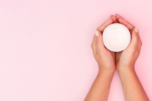 woman holding face cream box with copy space. High resolution photo