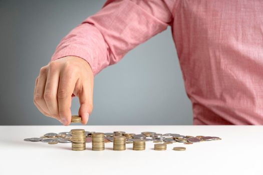 man stacking coins desk. Beautiful photo