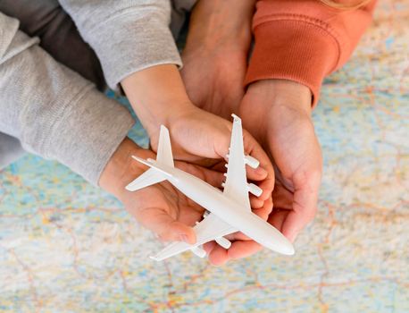 mother child home holding airplane figurine top map. Beautiful photo