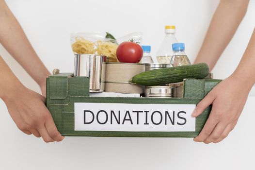 volunteers holding box filled with food donation. Resolution and high quality beautiful photo