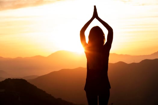 woman sunset doing yoga. High resolution photo