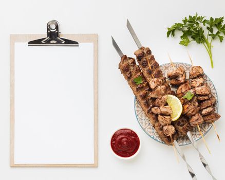 flat lay notepad with plate delicious kebab ketchup. Beautiful photo