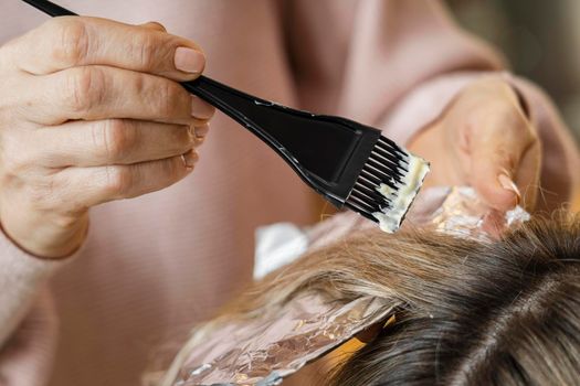 woman getting her hair dyed home by beautician. Beautiful photo