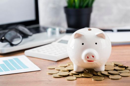 piggy bank with coins laptop. High resolution photo