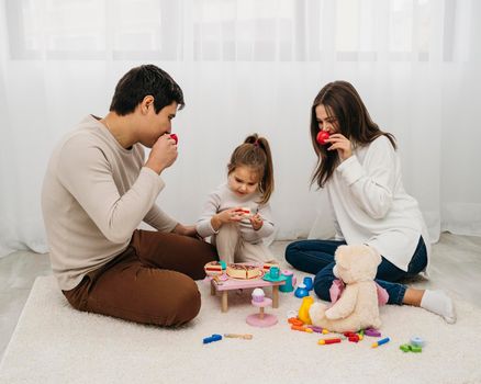 daughter parents playing together home. High resolution photo