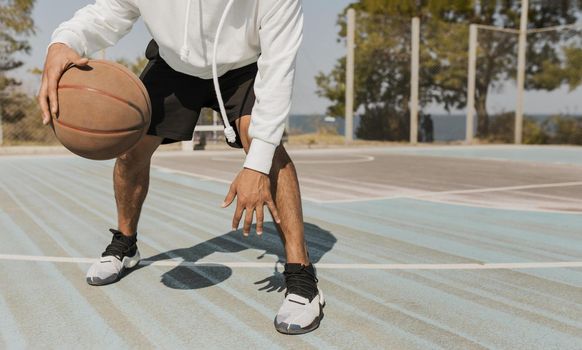 front view young man playing basketball outside 2. Resolution and high quality beautiful photo