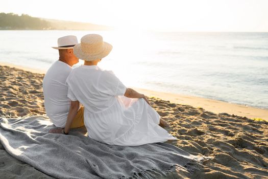 full shot couple sitting blanket. High resolution photo