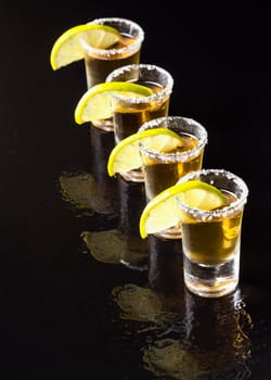 high angle line gold tequila shots. High resolution photo