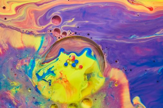 Image of Mystical rainbow of colors on liquid surface with tiny acrylic spheres