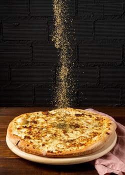 high angle dried herbs sprinkled pizza. High resolution photo