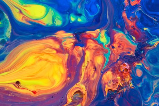 Image of Swirls of rainbow colors on liquid surface
