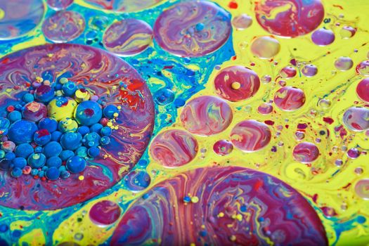 Image of Mesmerizing surface of liquid in rainbow colors with circles and spheres