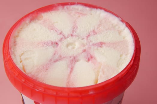 close up of vanila flavor ice cream in a container .