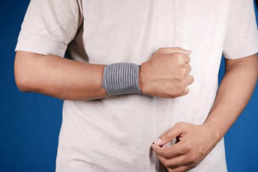 hand with wrist support against blue background