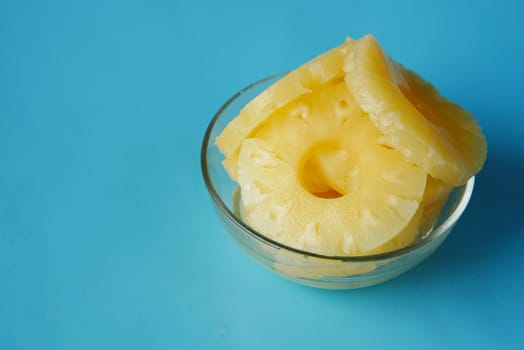 slice of pineapple in bowl on table .