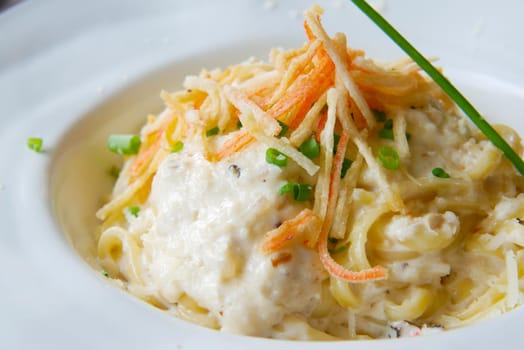 plate of cream and herb pasta on table ,