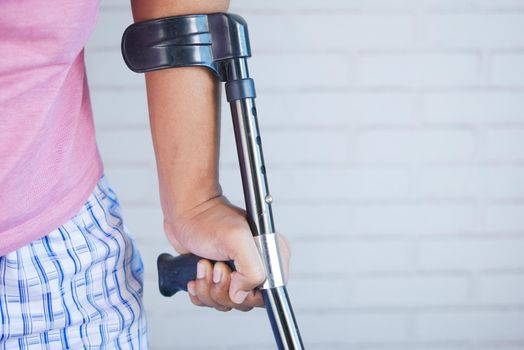 young man with broken leg on crutches