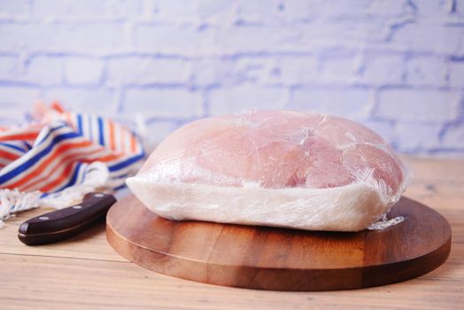 raw chicken breast in a packet on table .