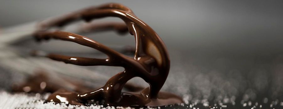 close up whisk with melted chocolate sugar. Beautiful photo