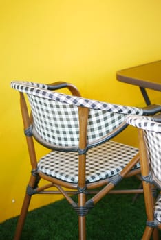 empty chair at cafe against yellow background ,