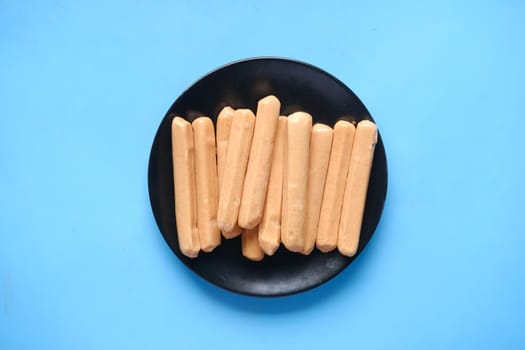 many sausages on a plate on blue background ,