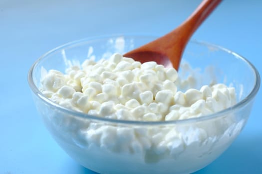 close up of cottage cheese on spoon on table