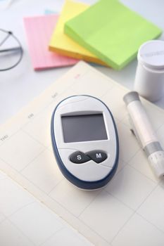 diabetic measurement tools on a planner on table .