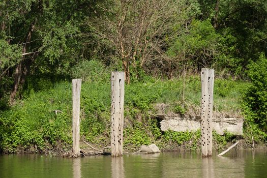 The pillars out of the water are the remains of an old bridge