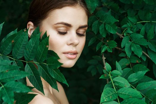 portrait of a woman Cosmetology nature green leaves glamor model. High quality photo