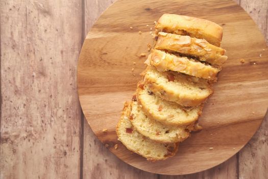 slice of bakery fruit cake on chopping board ,