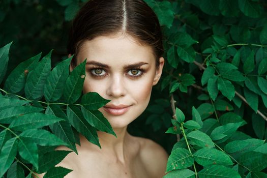 portrait of a woman Cosmetology nature green leaves glamor model. High quality photo