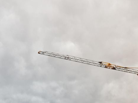 Crane hand against cloud sky. Abstract picture with negative space.