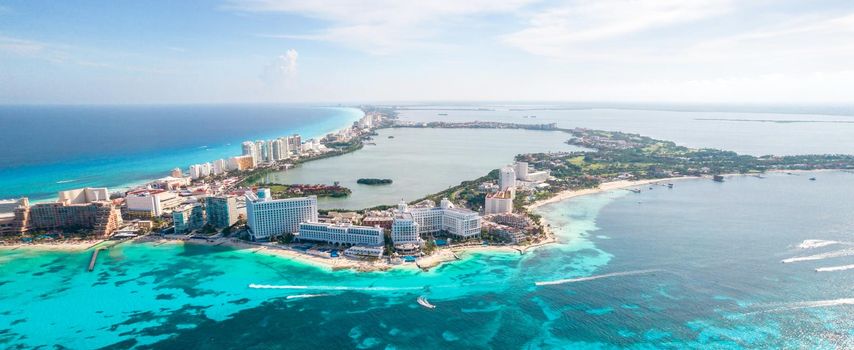 Aerial panoramic view of Cancun city hotel zone in Mexico. Caribbean coast landscape of Mexican resort with beach Playa Caracol and Kukulcan road. Riviera Maya in Quintana roo region on Yucatan Peninsula