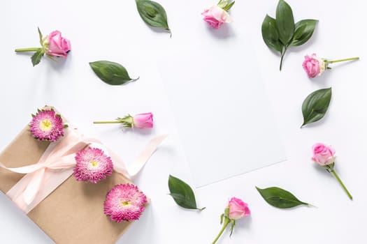 high angle view flowers leaves with gift box white surface. High resolution photo