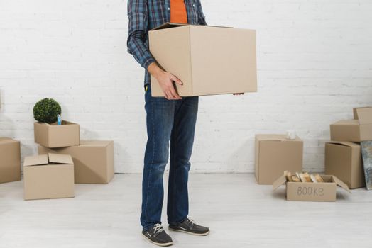 low section man holding cardboard box his hand. Resolution and high quality beautiful photo