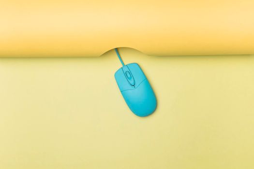 top view blue computer mouse with yellow background. High resolution photo